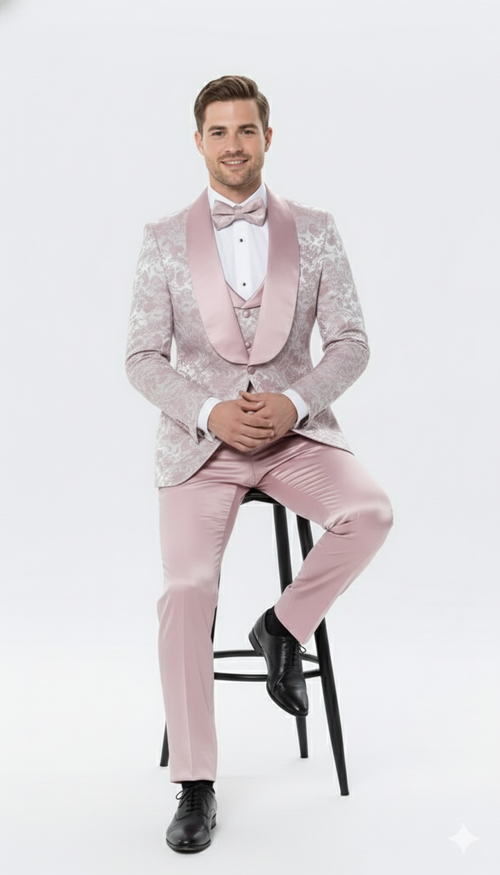 Light pink dusty rose floral tuxedo suit: fitted silhouette, shawl lapel, floral jacket, solid pink trousers. Includes matching bow tie and vest, smooth fabric. Cohesive color scheme.