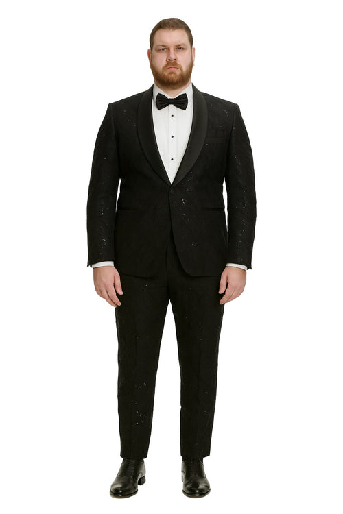 Black sequin tuxedo suit with satin shawl lapel. Fitted design, textured sequins. Tailored trousers match the blazer. White shirt and black bow tie complete the look.