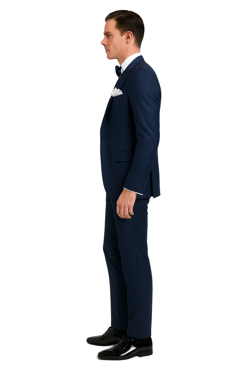 Navy tuxedo with satin peak lapel. Crafted from navy sateen. Three-piece formal suit: vest, bow tie. Slim fit, structured silhouette.