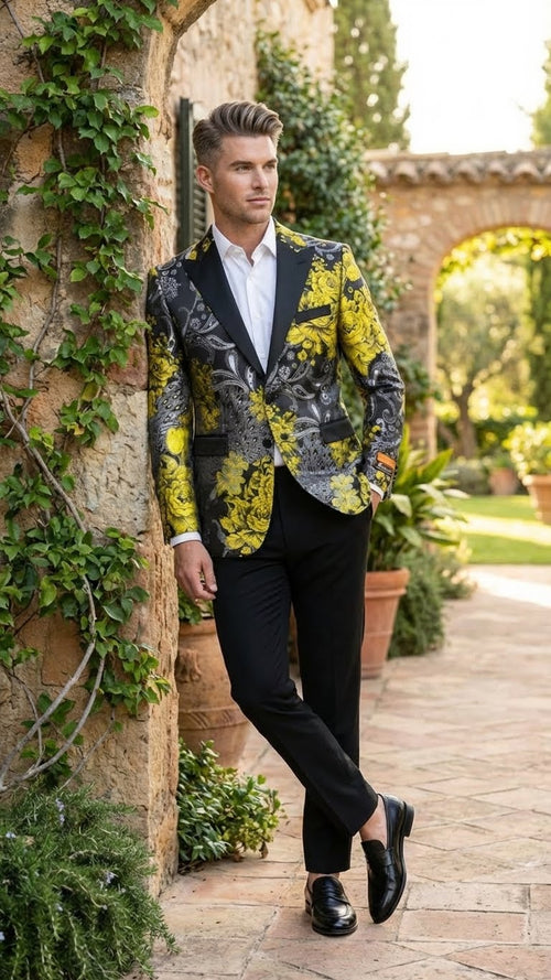 Yellow men's tuxedo blazer with black & gold floral pattern. Fitted silhouette, shawl lapel, single-button closure, and two front pockets. Primarily yellow with intricate floral designs.