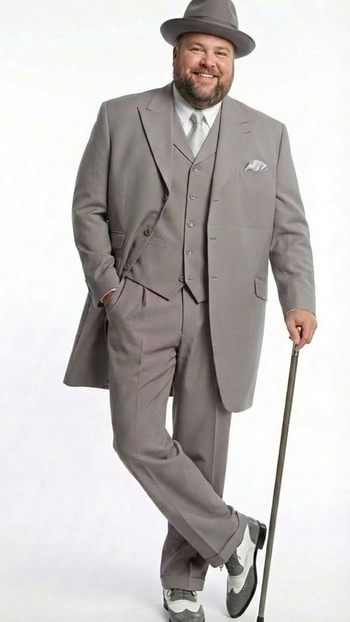 Gray zoot suit for men: long, tailored jacket, three-piece with vest, wide-legged trousers. Includes a matching hat. Worn with black and white 1920s-style Oxford shoes.