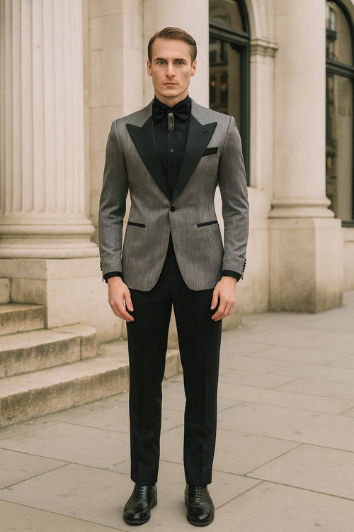 Silver metallic tuxedo suit with black satin peak lapel. Fitted jacket, long sleeves, single-button closure. Tailored black trousers. Includes black shirt and bow tie.