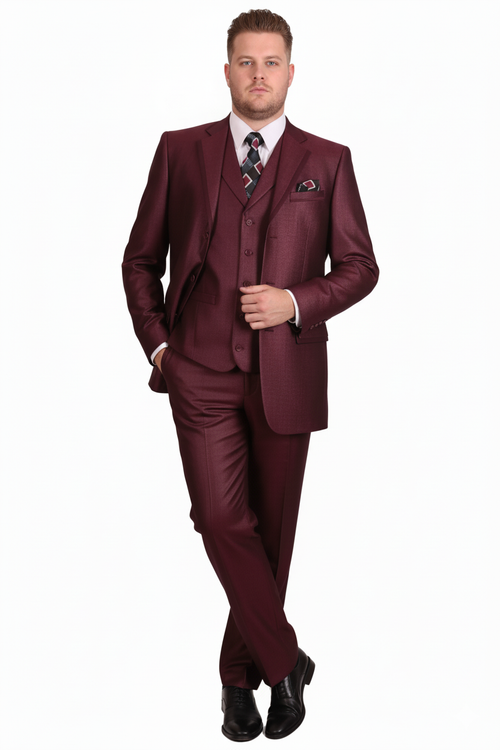 Burgundy three-piece suit: fitted single-breasted jacket, matching trousers, and waistcoat. Smooth, shiny fabric. Includes notch lapels, pocket square, and button-down waistcoat. Paired with a patterned tie and black shoes.