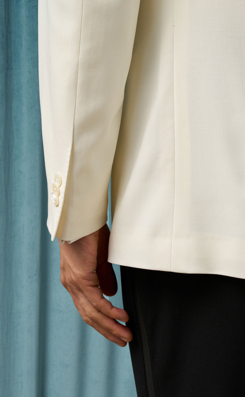 Men's ivory dinner jacket: Smooth, tailored fit in lightweight fabric. Cream color, single-button closure, three cuff buttons. Notch lapel, clean lines, back vent.