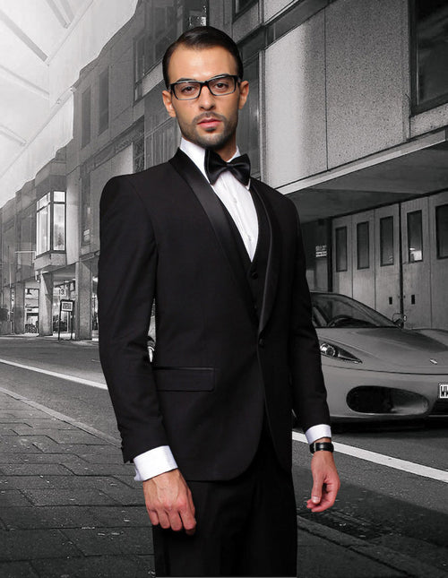 Men's black wool tuxedo. Modern fit, one-button, shawl lapel. Three-piece vested design. Includes white dress shirt and bow tie. Tailored structure.