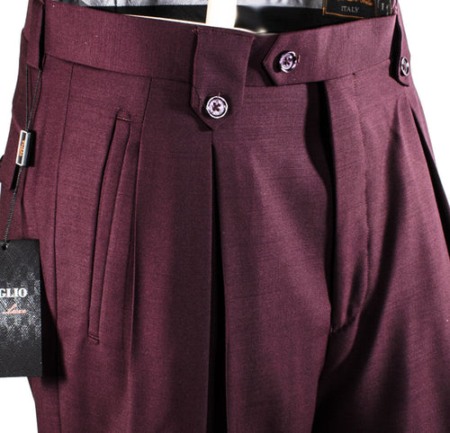 Burgundy Tiglio Luxe wool wide-leg dress pants. High-waisted with two front pleats, featuring a wide silhouette. Secured by two purple buttons. Solid burgundy fabric.