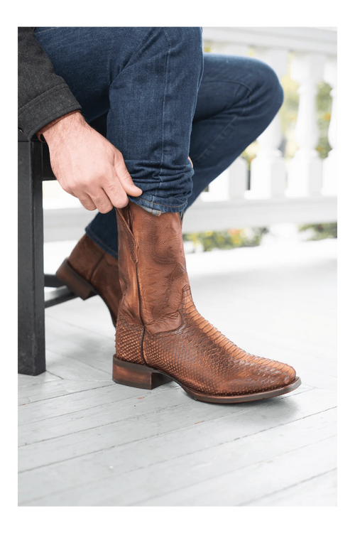 Dan Post men's brown leather boots with a python print. Square toe, low stacked heel, and embossed detailing. Pull tabs for easy wear and a sleek side profile.