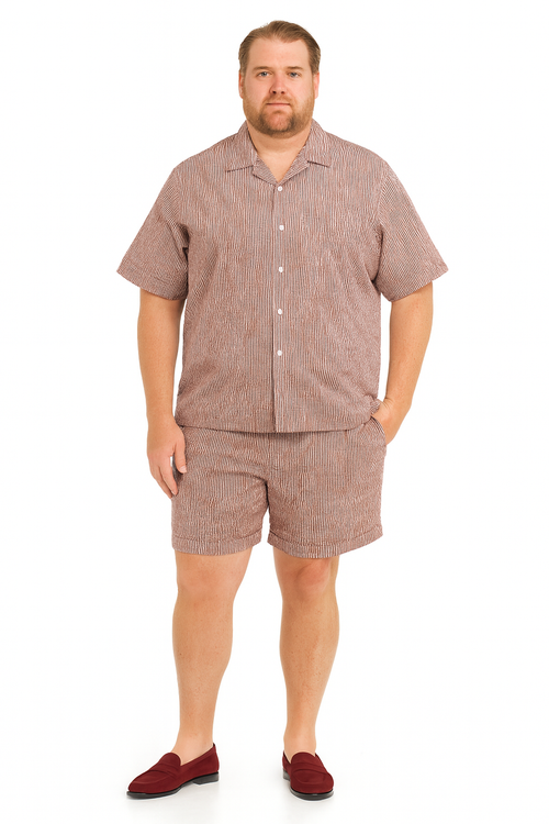 Men's burgundy seersucker short set: short-sleeved button-up shirt with notched collar & matching knee-length shorts. Striped burgundy & white pattern. Loose fit, lightweight fabric.