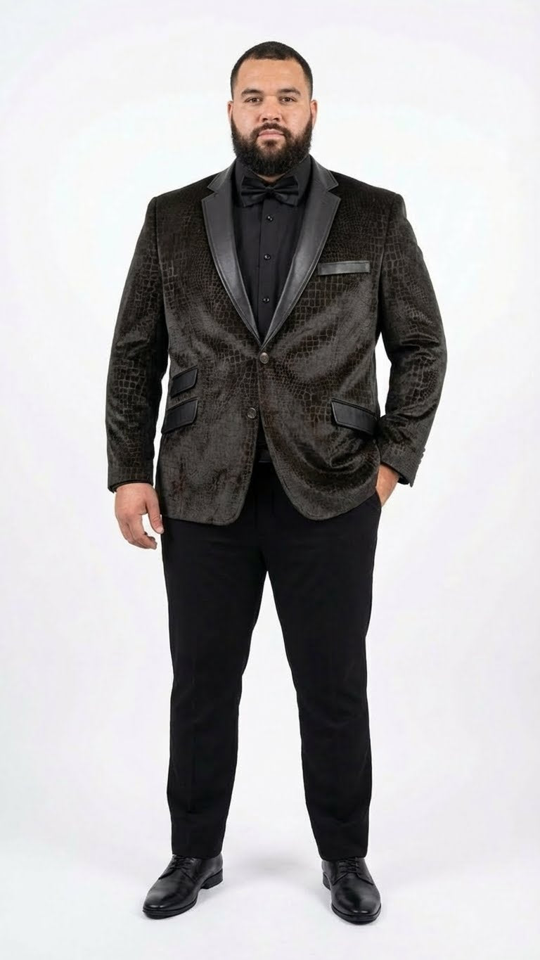 Dark brown men's blazer with crocodile/alligator skin texture, glossy finish, and black satin lapels. Structured shape, front pockets. Worn with black trousers and shoes.