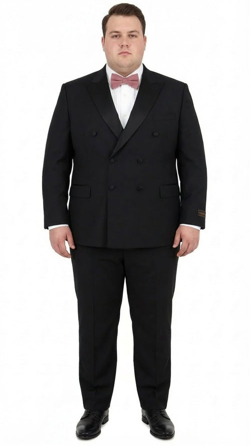 Elegant black double-breasted tuxedo in Italian Super 150s wool. Features peaked lapels & structured fit. Paired with white shirt, pink bow tie, and tapered trousers. Black dress shoes complete the look.