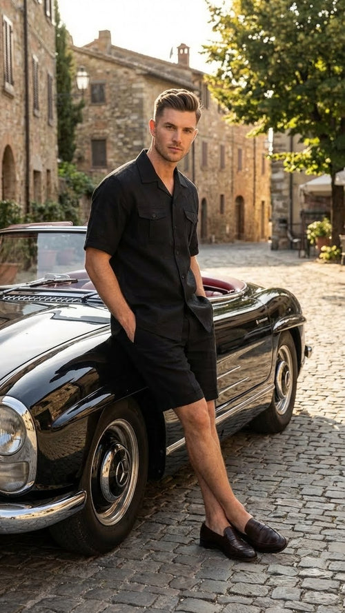 Men's black walking suit with shorts by Alberto Nardoni, consisting of a short-sleeved, button-up shirt and matching shorts. The outfit is made from a lightweight fabric and features a solid black color. The shirt includes two chest pockets and a straight cut, while the shorts are tailored to a mid-thigh length.
