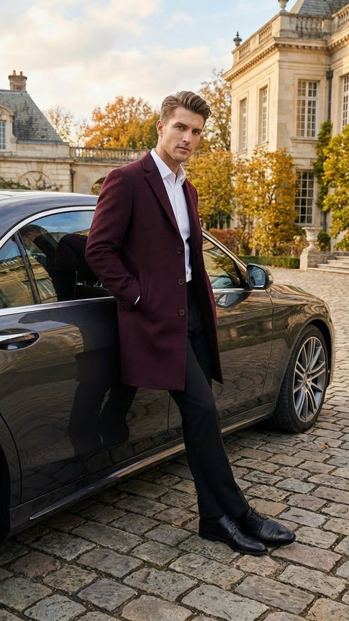 Alberto Nardoni men's burgundy overcoat. Mid-length, single-breasted, notched collar, textured fabric. Tailored silhouette, visible buttons, fitted shape, reaching above the knees.
