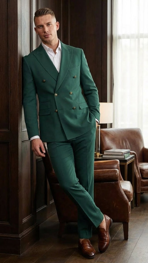 The vitali brand men's emerald green double-breasted suit features a fitted blazer with two rows of gold buttons and matching tapered trousers. The fabric appears smooth, maintaining a structured shape.