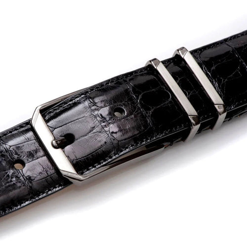 Black Mezlan crocodile belt: textured, glossy finish. Distinct crocodile pattern, sleek metal buckle. Multiple adjustment holes for flexible sizing.