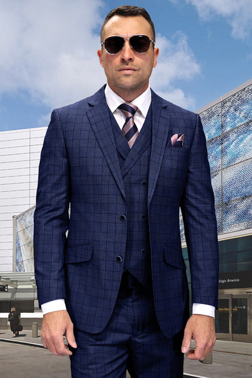 Sapphire blue wool suit with a windowpane plaid. Modern fit with a structured blazer, matching trousers, and vest. Features notch lapels, a four-button vest, and functional pockets. Designed for a clean, modern silhouette.
