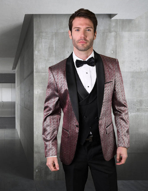 Burgundy herringbone tuxedo with shawl lapel, metallic & textured fabric. Includes black vest/shirt, fitted silhouette, and black trousers. One-button closure and two front pockets.