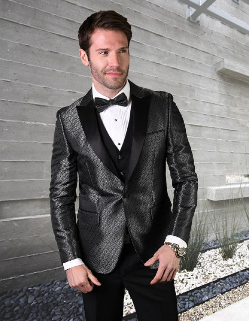 Black men's tuxedo with peak lapels and a subtle shiny pattern. Fitted design includes a vest, long sleeves, and pockets. Completed with a white dress shirt and bow tie.