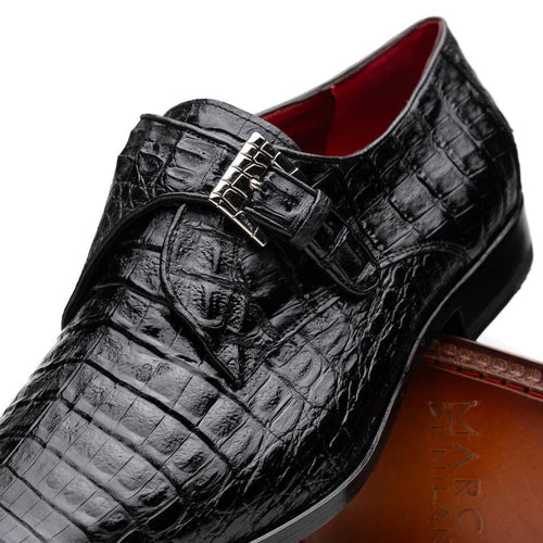 Black caiman crocodile dress loafers with single monk strap and metal buckle. Textured crocodile skin pattern on the surface.
