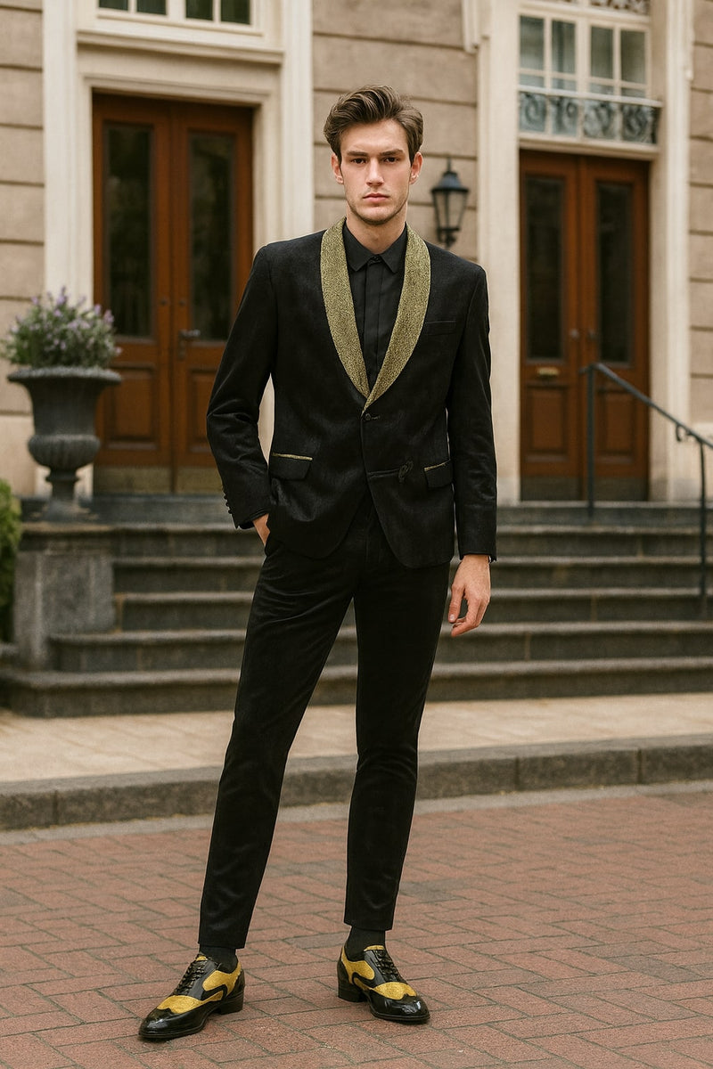 Black jacquard tuxedo blazer with gold shawl collar. Fitted shape, sleek textured material, subtle pattern. Paired with black trousers for a uniform, luxury look.