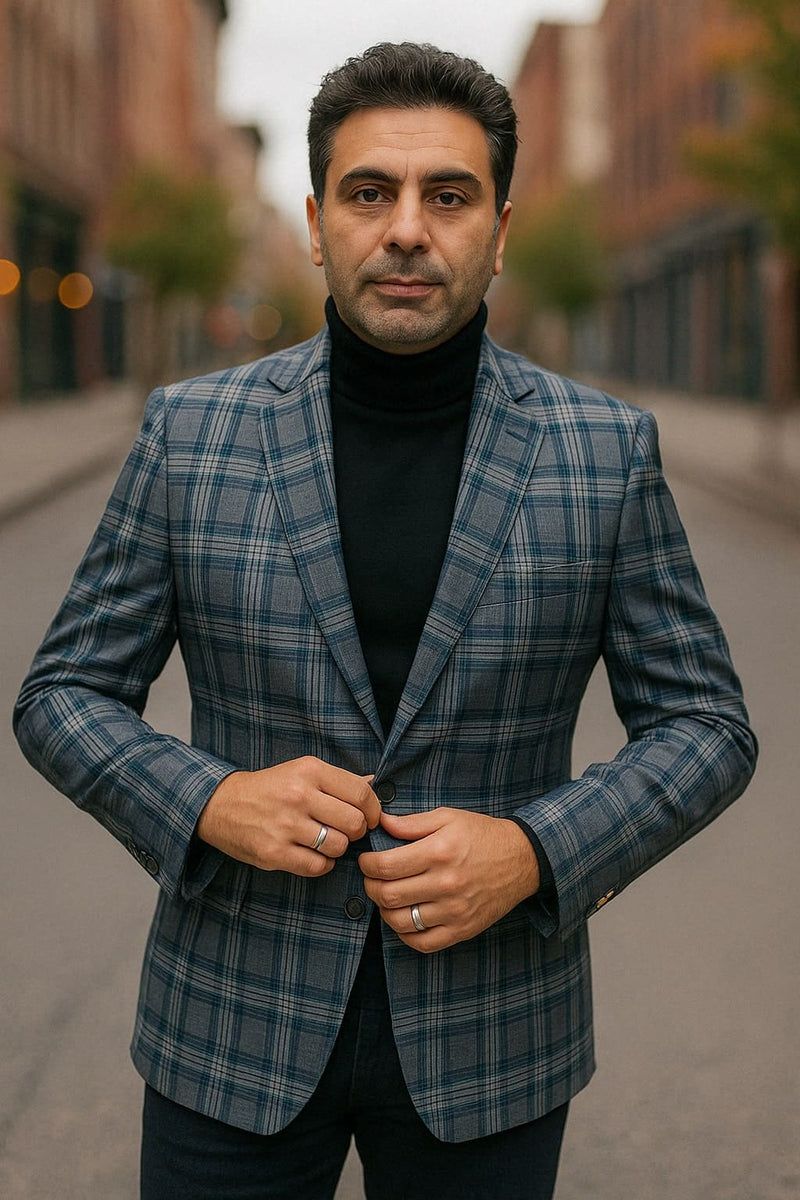 Alberto Nardoni men's blazer in blue/grey windowpane plaid. Tailored fit, notched lapel, structured fabric. Blue base with alternating grey squares. Styled over a black turtleneck.