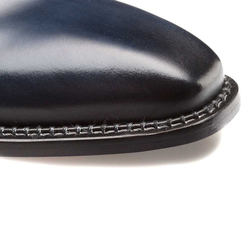 Blue calfskin enterprise dress shoe. Plain toe, rounded. Smooth surface, contrasting hand-stitched sole detail.