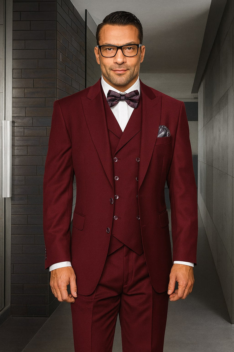 Men's urban suit in burgundy 100% wool. Features a single-button, double-breasted vest layered under a jacket, and pleated pants. Structured tailoring creates a uniform, sophisticated look.