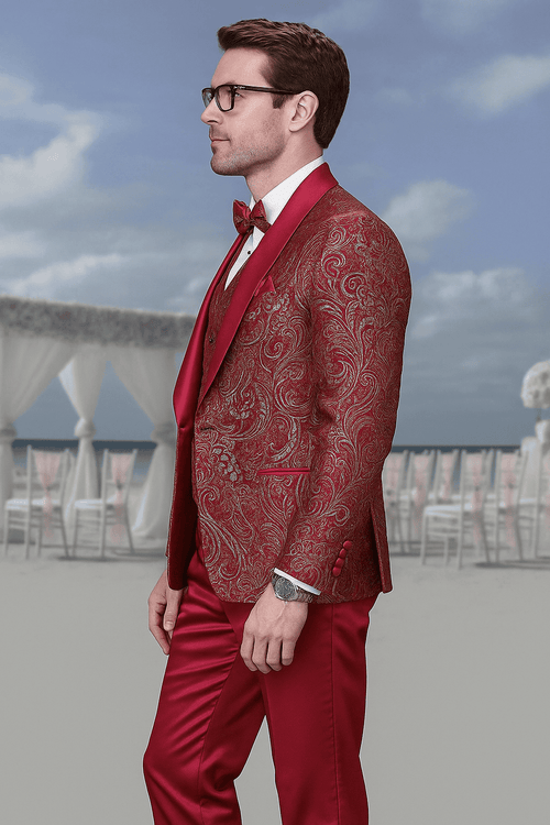 Red paisley brocade tuxedo for men. Double-breasted, vested, tailored fit. Rich red fabric with paisley pattern. Matching bow tie. Glossy trousers.