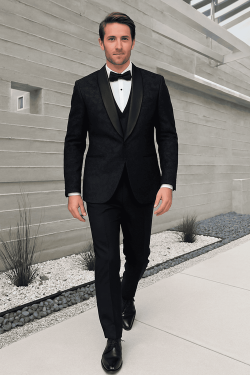 Black paisley velvet tuxedo with vest. Double-breasted jacket, satin lapel. Includes white shirt & black bow tie. Black pants complete the formal look.