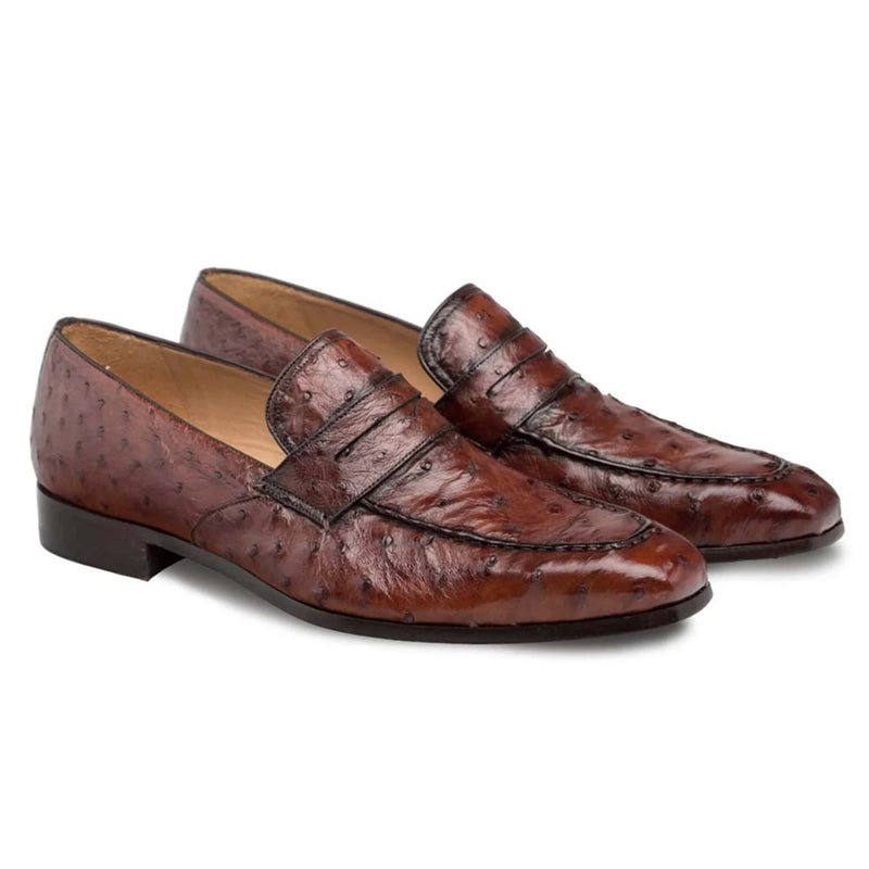Mezlan Lisbon slip-on loafer in brandy ostrich leather. Sleek, elongated shape with decorative band. Textured surface, low heel, and smooth, rounded toe.