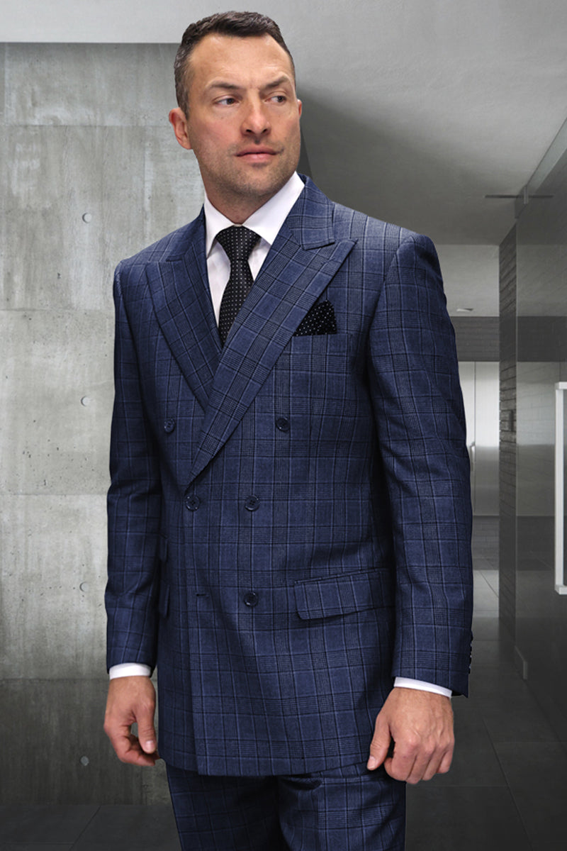 Classic fit sapphire blue plaid wool suit. Double-breasted jacket with wide lapels and matching trousers. Textured fabric, tailored shoulder lines, and flap pockets. Formal and structured.