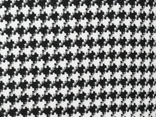 Black houndstooth hybrid double-breasted jacket. Structured, tailored fit with repeating black and white pattern. Textured fabric, potentially outerwear material. Formal style, double-breasted buttons.