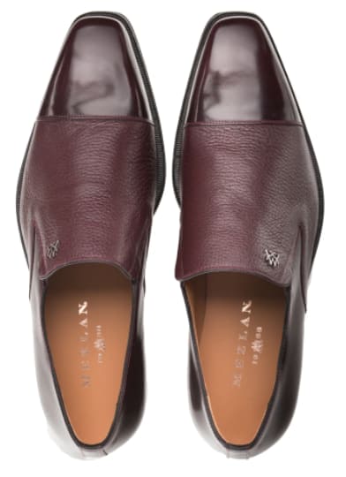 Burgundy Milani slip-on dress shoes in calfskin/deerskin. Polished toe cap, textured side panel. Sleek, streamlined design, no laces. Subtle brand logo.
