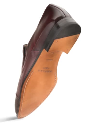 Burgundy calfskin & deerskin slip-on with rounded toe. Smooth upper, tan leather sole, and a 1-inch curved heel. A sophisticated, dressy design.