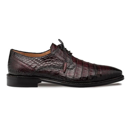 Burgundy crocodile derby shoes with a cap toe and pointed silhouette. Black leather sole and rounded laces. Structured shape.
