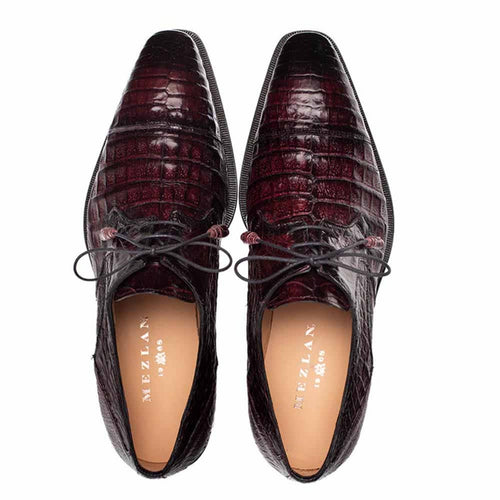 Mezlan men's burgundy crocodile derby shoes. Young Fuscus style with cap toe and pointed silhouette. Features textured crocodile leather exterior, black laces, and light-colored lining.