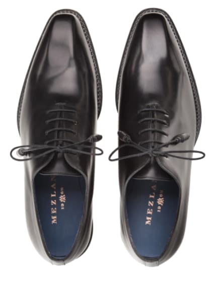 Mezlan's Enterprise balmoral: polished black calfskin with pointed toe. Traditional lace-up, visible stitching, and blue lining. Flat soles for a formal look.