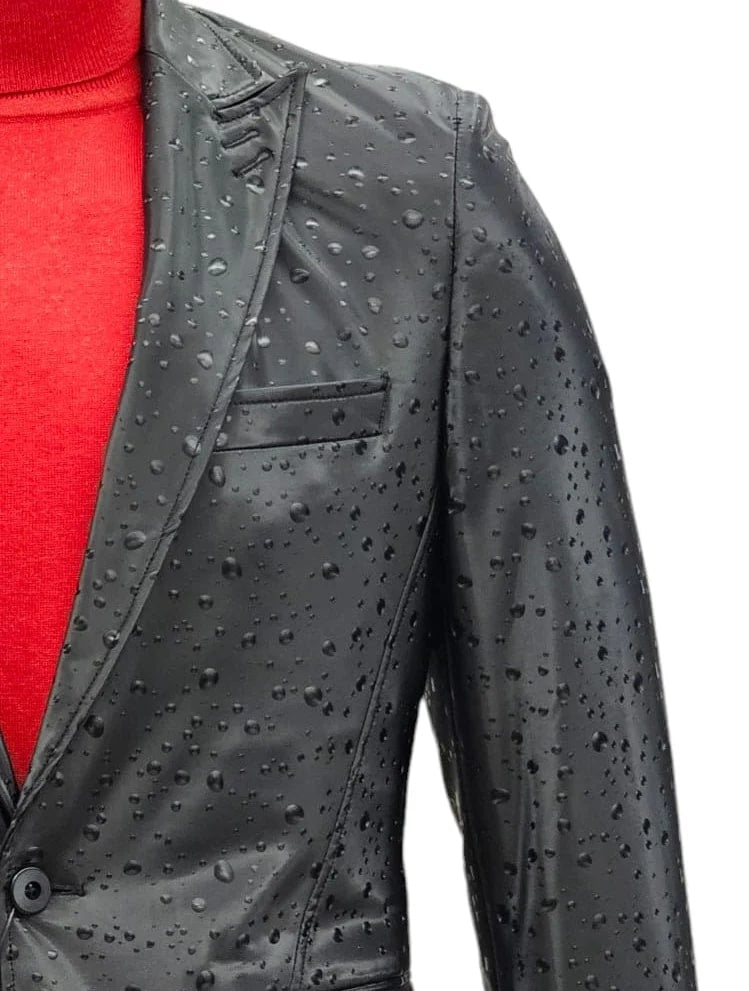 Men's black, one-button suit with peak lapels. Rain-resistant, smooth texture, and tailored shape. Features a single chest pocket.