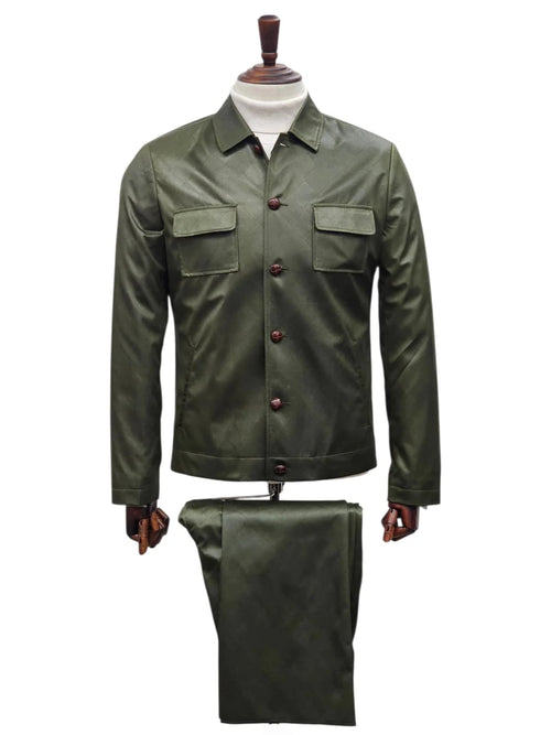 Olive green men's slim fit faux leather suit. Includes button-up shirt with front pockets, collared neckline, and matching trousers. Smooth, glossy finish with brown buttons.