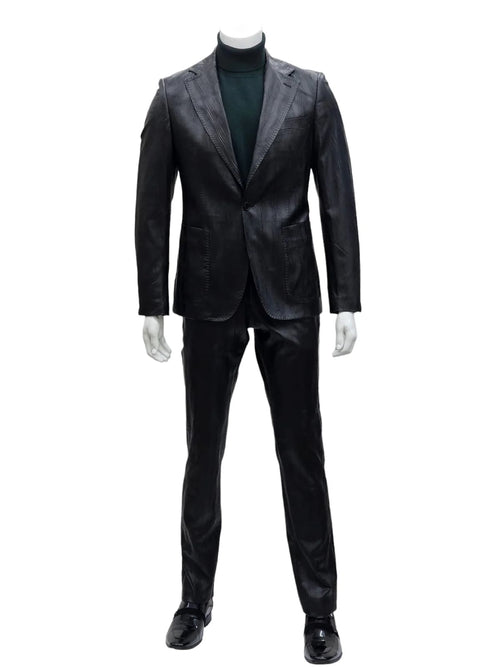 Men's slim fit two-piece suit in black. Features: one-button closure, notch lapel, textured fabric. Tapered waist, fitted trousers with straight leg, chest and front pockets. Reflective fabric.