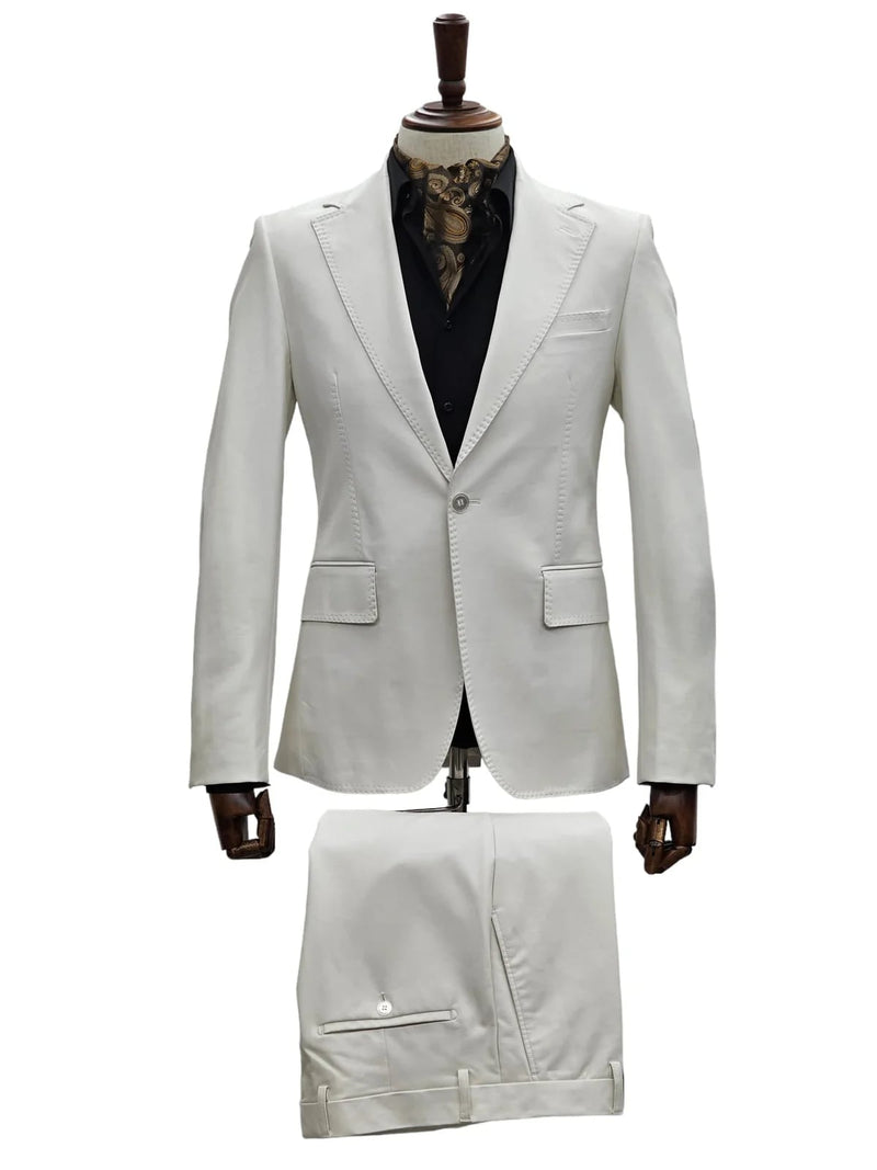 Men's bone-colored slim fit leather suit. Tailored blazer with one button, notch lapels, and pockets. Flat-front trousers with side and rear pockets. Smooth leather for a sleek silhouette.