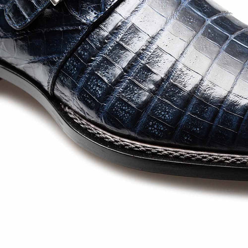 Mezlan Gigolo blue crocodile monk strap loafers. Smooth, textured blue crocodile leather upper with scales. Sleek shape, single strap with metallic buckle. Contrasting sole stitching and durable sole.