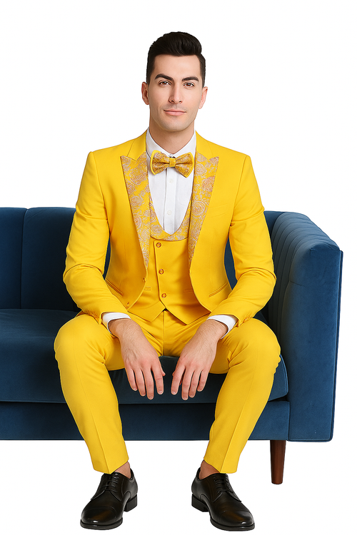 Golden three-piece suit: jacket with floral peak lapels, vest, tailored trousers. Smooth fabric. Paired with white shirt, bow tie. Modern fit. Completed with black shoes.