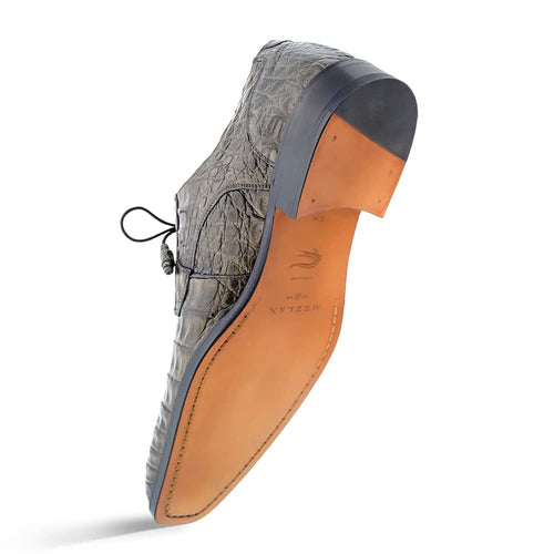 Mezlan Anderson men's shoe: Gray crocodile leather upper, black heel. Light tan leather sole with stitching. Lace-up closure, pointed toe, slightly raised heel. Exotic and stylish.