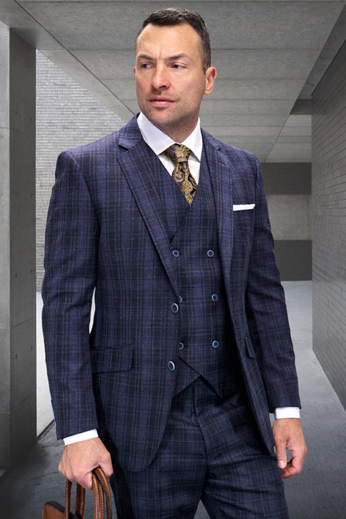Men's sapphire blue wool suit with a modern fit and windowpane plaid. Includes a vest. Features a tailored silhouette, button detailing, notched lapel, and contrasting buttons. Blends dark and light blue wool for a sleek look.