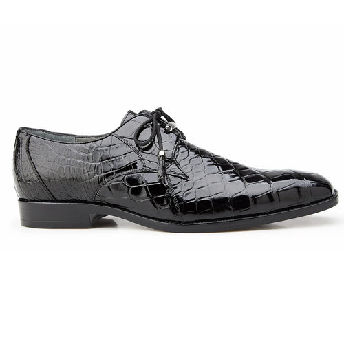 Black alligator leather Belvedere Lago dress shoe. Elongated shape, pointed toe, glossy finish. Lace-up closure with thin laces. Contrasting flat sole. Crocodile-like texture.