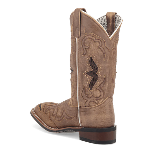 Laredo Women's Spellbound Boot: Tall, light brown suede-like boot with pointed toe and curved shaft. Features decorative stitching, dip at top, pull-on loop, and stacked heel.
