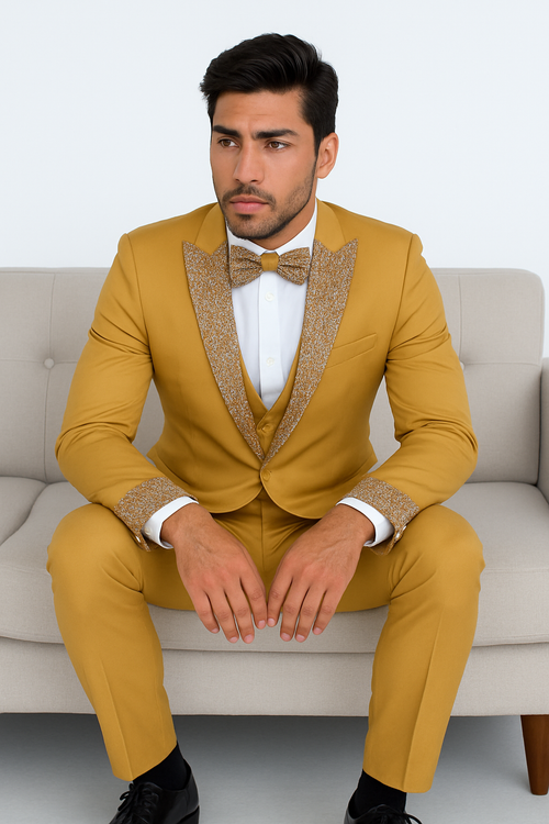 Champagne gold prom tuxedo: fitted jacket, glitter shawl collar/cuffs, matching vest/bow tie. Slim-fit trousers. Modern, eye-catching style.