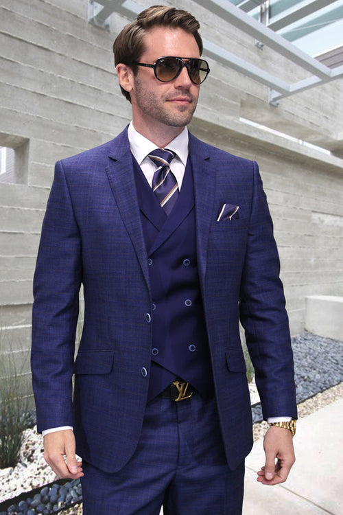 Sapphire blue sharkskin suit: double-breasted vest, structured blazer, flat-front trousers. Tailored modern fit. Textured fabric.