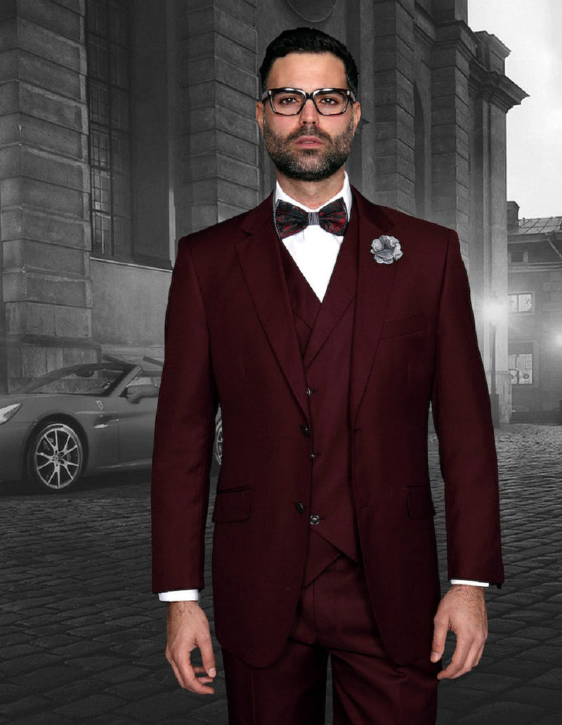 Burgundy men's classic fit suit with double-breasted vest. Features a two-button jacket, pleated pants, and matching vest. Formal, tailored style with a smooth fabric.