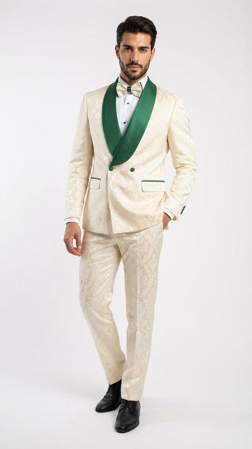 Ivory jacquard tuxedo suit with emerald green shawl collar & accents. Structured jacket, two buttons, decorative pockets. Matching embossed pants, fitted silhouette.